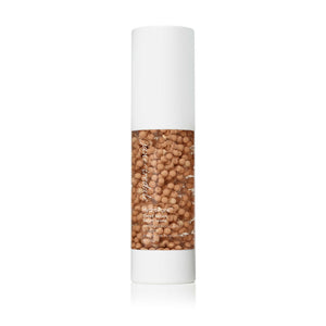 Bottle of HydroPure™ Tinted Serum with Hyaluronic Acid & CoQ10 | Jane Iredale featuring a clear container filled with beige tinted serum pearls and a white cap, designed for skincare use.