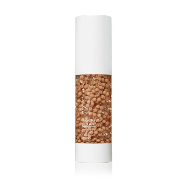 Bottle of HydroPure™ Tinted Serum with Hyaluronic Acid & CoQ10 | Jane Iredale featuring a clear container filled with beige tinted serum pearls and a white cap, designed for skincare use.