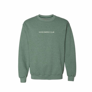 Green crew neck sweatshirt with "GOOD ENERGY CLUB" text on front, showcasing Mentally I’m At The Spa Unisex Crew Neck Sweatshirt | Lucky Owl for casual wellness-inspired style.