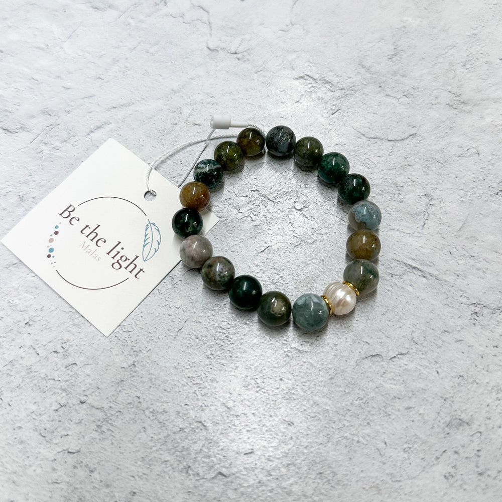 Jasper Luxe Bracelet | Be the Light featuring polished multi-colored natural stone beads with a small gold accent bead, displayed on a light textured surface with a branded tag.