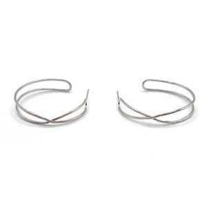 Pair of minimalist silver open hoop earrings with an elegant crisscross design, showcasing the Infinity Hoops | Purpose Jewelry style.