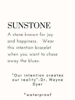 Close-up of a card describing Sunstone, a stone symbolizing joy and happiness, with a motivational quote and mention of the Joy Intention Bracelet | Meghan Bo as a wearable reminder to chase away the blues, waterproof included.