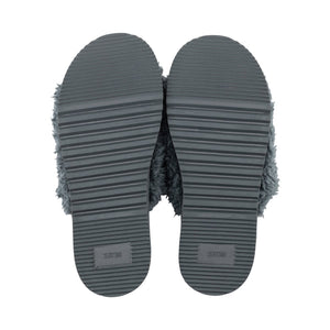 Anywhere Berber Slide | Lemon shown from the sole side with durable black textured grips and a soft fuzzy upper edge visible around the soles.