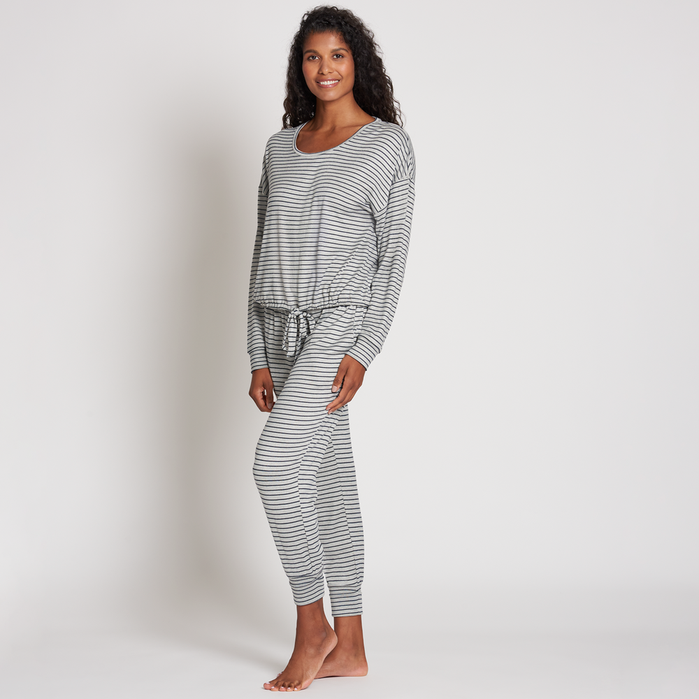 Woman wearing a comfortable striped lounge outfit standing barefoot, showcasing the Jogger Sleep Set - 2PC | Lemon in a relaxed pose.