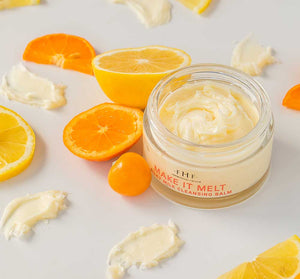 Make it Melt Silky Milk Cleansing Balm | Farmhouse Fresh in a jar surrounded by fresh citrus slices and creamy balm texture, highlighting skincare and natural ingredients.