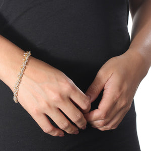 Close-up of a person wearing the Fringe Bracelet | Catherine Weitzman Jewelry, featuring delicate gold and clear beaded fringe details on the wrist against a black top background.