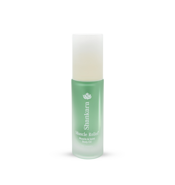 Green frosted glass bottle of Muscle Relief Oil | Shankara with a white cap, designed for muscle and joint body care and wellness.