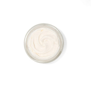 Open jar of creamy white skincare product with smooth texture, representing Necks-Level Smooth™ Cream | Farmhouse Fresh designed for neck care and wellness.