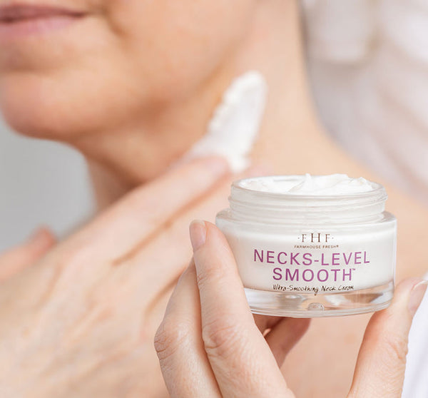 Close-up of a person applying Necks-Level Smooth™ Cream | Farmhouse Fresh to the neck, highlighting skincare for smooth, hydrated skin.