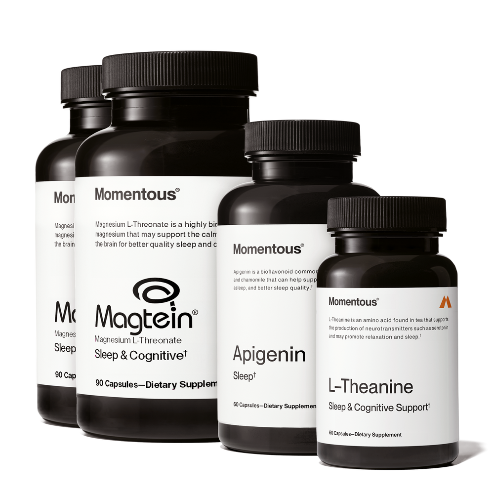 Four black supplement bottles labeled Momentous including Magtein, Apigenin, and L-Theanine arranged in a row promoting Nightly Sleep Stack for sleep and cognitive support.