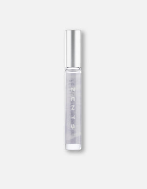 Clear glass roll-on bottle with silver cap containing a light purple fragrance labeled Attar Roll-on Scent | Zents for personal wellness and body care.