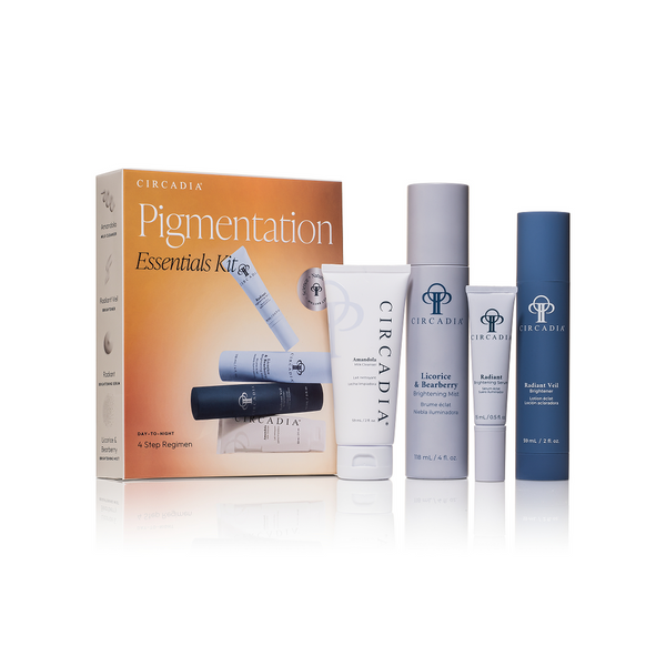 Pigmentation Essentials Regimen Kit | Circadia displaying four skincare products including a cleansing cream, brightening mist, and two serums in white, gray, and blue packaging arranged next to the product box.