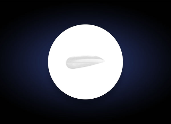 Close-up of a smooth white serum sample on a white circular background against a dark backdrop, showcasing the texture of Vitamin B3 Brightening Serum | PCA Skin for skincare use.