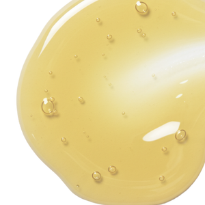 Close-up of a smooth, golden serum texture with bubbles, representing Pure Oxygen Serum | Skin Fitness Therapy for skincare and wellness treatments.