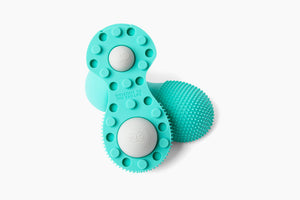Neuro Roller | RAD in teal color featuring textured surfaces and raised nodes designed for targeted body care and muscle recovery wellness therapy.