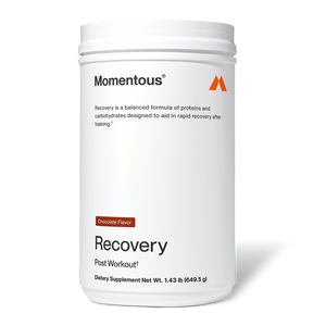 White container of Recovery dietary supplement in chocolate flavor by Momentous, designed to support rapid recovery after training with proteins and carbohydrates.