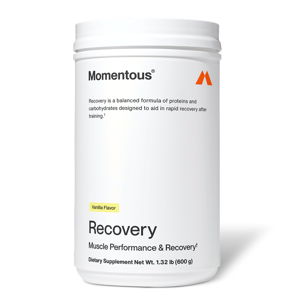 White container of Recovery dietary supplement in chocolate flavor by Momentous, designed to support rapid recovery after training with proteins and carbohydrates.