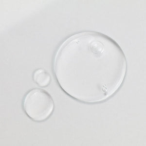 Clear hydration serum droplets on a smooth surface representing the texture of Daily Dose Of Water™ Hyaluronic Acid Hydrating Serum | ClarityRx skincare product.