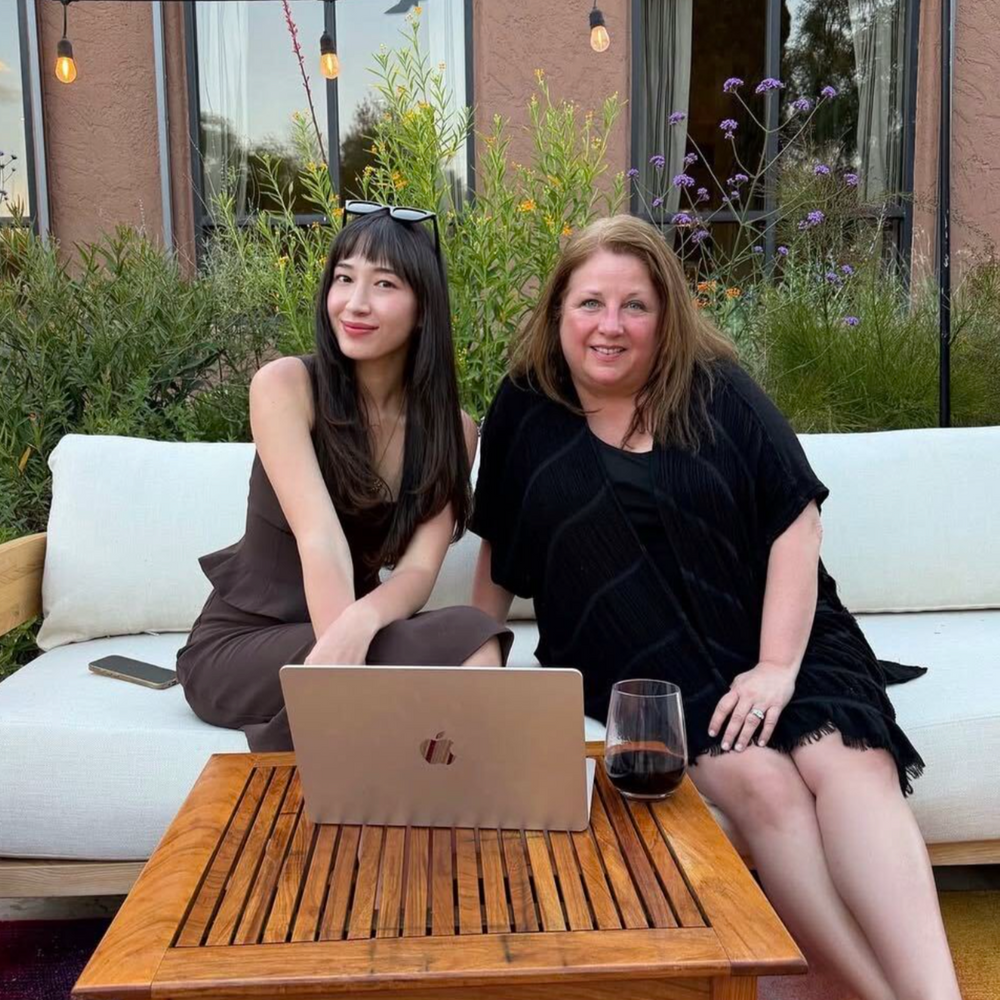 Two women in an outdoor lounge with a laptop and tablet during Astrology Lounge (Full Day)- Astrology Readings | Alexa Michaelis