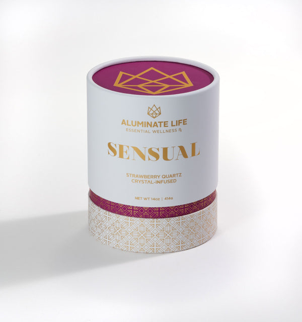 Sensual Glass Candle | Aluminate Life in white and gold packaging with purple accents, featuring strawberry quartz crystal-infused design for wellness and relaxation.