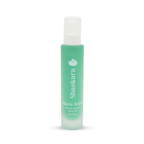 A green frosted glass bottle of Muscle Relief Oil | Shankara, designed for muscle and joint body care, featuring a white spray cap and minimalist text branding.