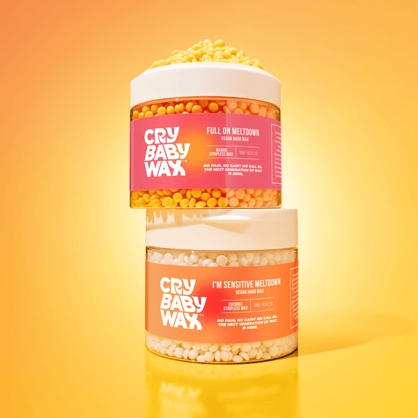 Two stacked containers of I'm Sensitive Meltdown Vegan Hard Wax | Crybaby Wax with yellow and white wax beads inside, set against a bright yellow background for skincare and body care.