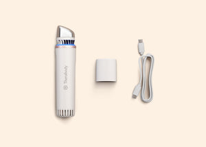 TheraFace Depuffing Wand | Therabody device in white with blue light, charging adapter, and USB-C cable displayed on a light background for skincare and wellness use.