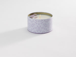 Release Candle Tin 6 oz | Aluminate Life displayed on a white surface, featuring a decorative patterned container with a creamy white wax and a small wick at the center.