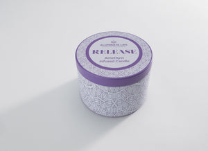 Release Candle Tin 6 oz | Aluminate Life featuring a purple and white patterned tin with amethyst-infused candle for wellness and relaxation.
