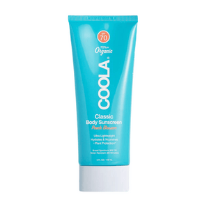 Peach Blossom Classic Body Sunscreen Lotion SPF 70 | COOLA in a blue tube, offering ultra lightweight, hydrating, and nourishing body care with broad spectrum SPF 70 protection.