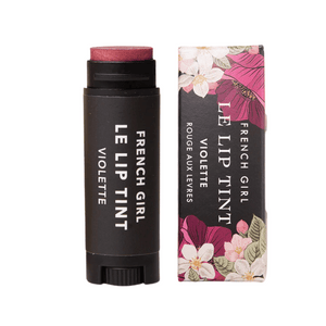 Le Lip Tint | French Girl in Violette shade, a creamy stick lip tint with floral-themed packaging, designed for a natural, radiant look.