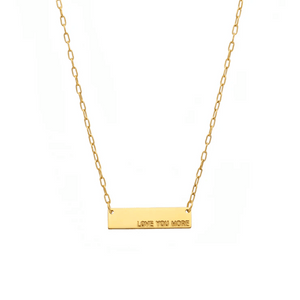 Love You More Plaque Necklace (Gold) | Love You More featuring a delicate gold chain with a rectangular plaque engraved with the words "LOVE YOU MORE" for a simple, elegant look.