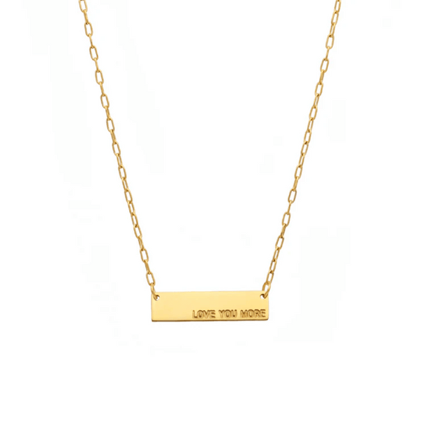 Love You More Plaque Necklace (Gold) | Love You More featuring a delicate gold chain with a rectangular plaque engraved with the words "LOVE YOU MORE" for a simple, elegant look.
