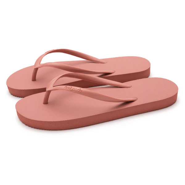 Pair of coral-colored slim flip-flop sandals with simple straps, designed for casual wear, Slimz Core Sandals | Feelgoodz.