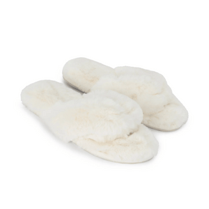 Pair of soft white faux fur slippers with open toes and crisscross design, labeled Waterfront Solid Faux Fur Flip-Flop - White | Lemon, perfect for cozy indoor wear.