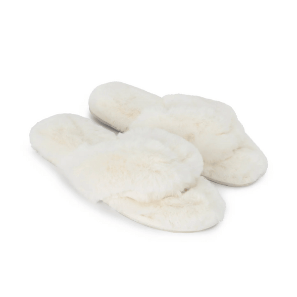 Pair of soft white faux fur slippers with open toes and crisscross design, labeled Waterfront Solid Faux Fur Flip-Flop - White | Lemon, perfect for cozy indoor wear.