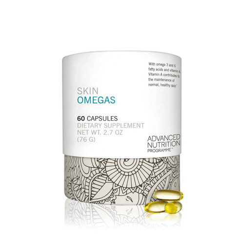 White container of Skin Omegas Supplement | Jane Iredale dietary capsules with decorative gray pattern and three yellow omega capsules placed beside it for skincare and wellness.