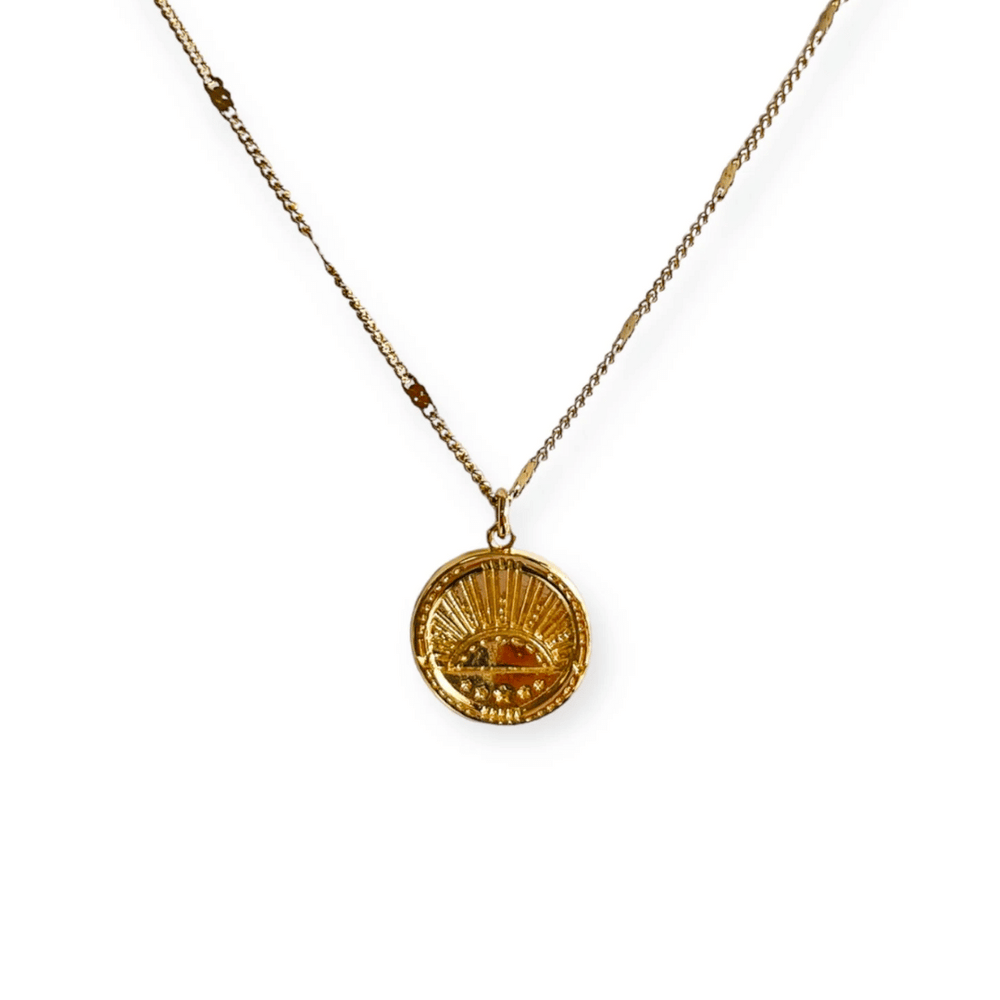 Golden Sunrise Necklace | Meghan Bo featuring a delicate gold chain and round pendant with a sun rising design, symbolizing warmth and new beginnings.