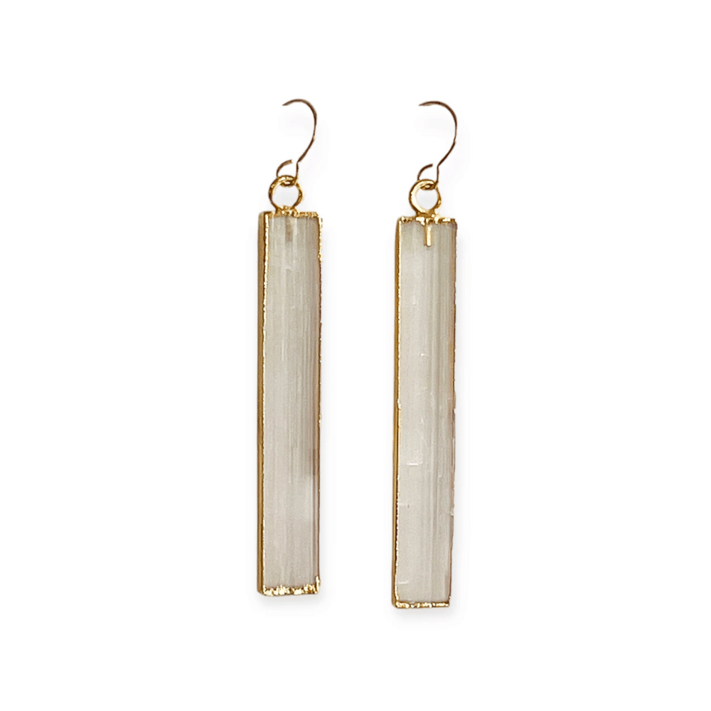 Pair of long rectangular selenite stone earrings with gold-tone metal edging and hooks, styled as elegant and minimal jewelry Selenite Earrings | Meghan Bo.