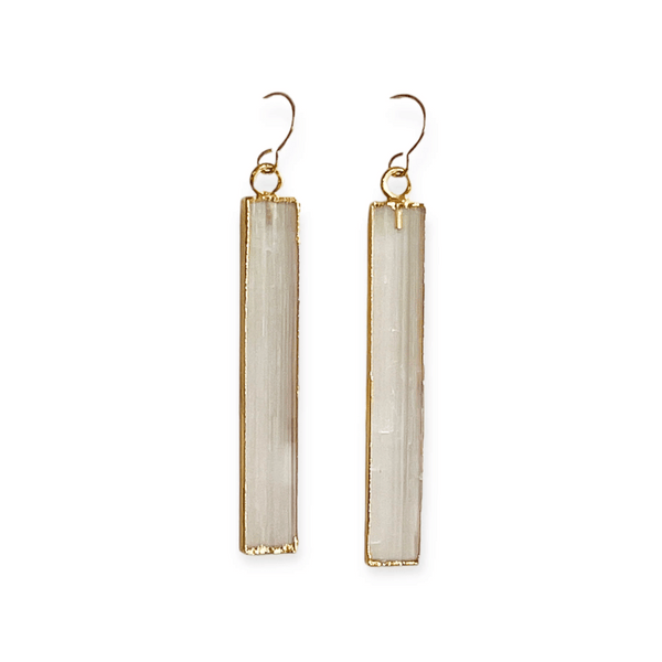 Pair of long rectangular selenite stone earrings with gold-tone metal edging and hooks, styled as elegant and minimal jewelry Selenite Earrings | Meghan Bo.