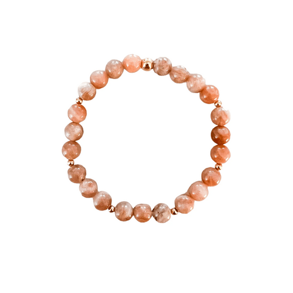 Joy Intention Bracelet | Meghan Bo featuring round peach-colored beads with gold accents, designed to promote wellness and positive energy.