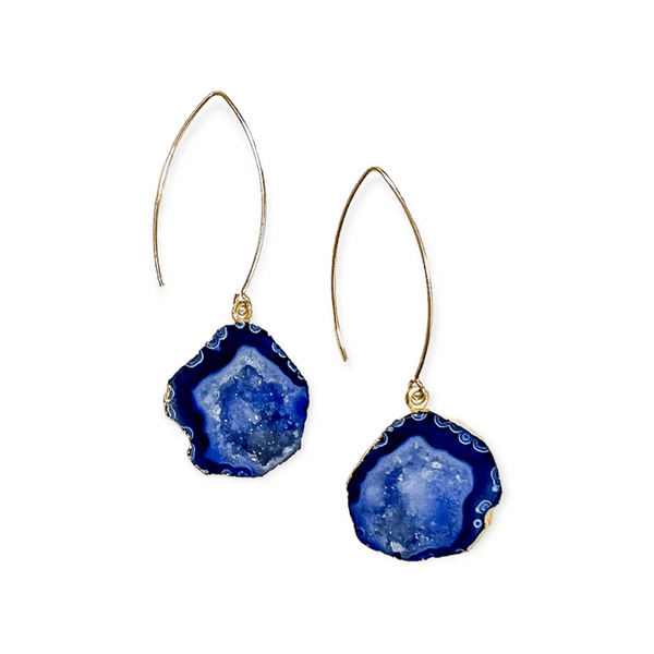 Pair of elegant Blue Geode Earrings | Meghan Bo with deep blue natural geode stones framed in gold, featuring delicate elongated gold hooks for a stylish, bohemian look.