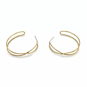 Pair of delicate gold-tone hoop earrings with a unique overlapping wire design, minimalist and elegant style by Infinity Hoops | Purpose Jewelry.