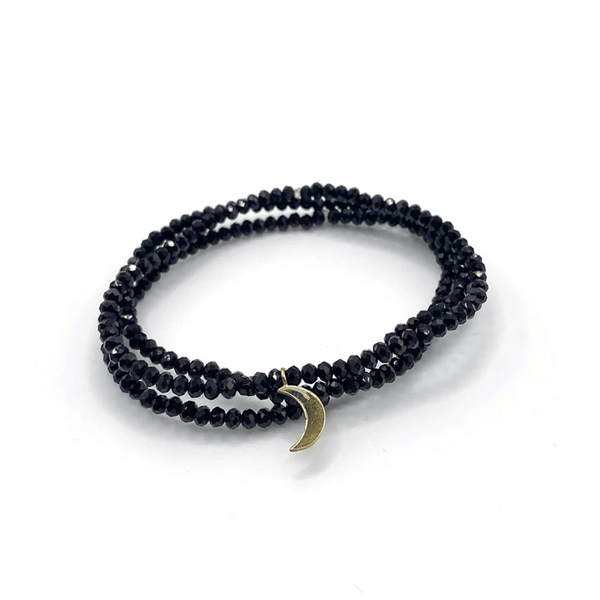 Dusk Stretch Bracelet | Purpose Jewelry featuring black faceted beads wrapped twice with a small crescent moon charm for a sleek, versatile wellness accessory.