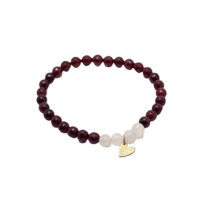 Gemstone Heart Bracelet | Purpose Jewelry featuring polished dark red beads, white accent beads, and a small gold heart charm on a stretchy band.