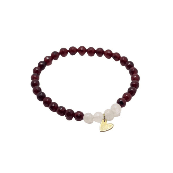 Gemstone Heart Bracelet | Purpose Jewelry featuring polished dark red beads, white accent beads, and a small gold heart charm on a stretchy band.