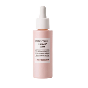 A pink dropper bottle of Luminant Serum | [ comfort zone ], a skincare product designed for dark spot correction using 3-Bright Technology.