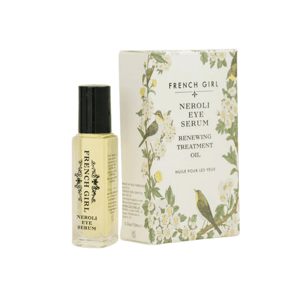 Neroli Eye Serum | French Girl in a small glass bottle with black cap next to a floral-themed box featuring birds, promoting a renewing treatment oil for skincare.