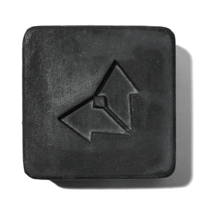 Charcoal Cleansing Bar x Brisa Hennessy | Vertra is a square black cleansing bar with a minimalist arrow logo embossed, designed for skincare and body care.
