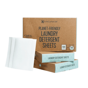 Stacked brown and blue boxes of Laundry Detergent Sheets | Force of Nature next to three white detergent sheets, highlighting eco-friendly laundry cleaning.